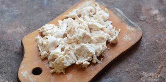 Слоёный салат с курицей, морковью, солёными огурцами и зелёным горошком